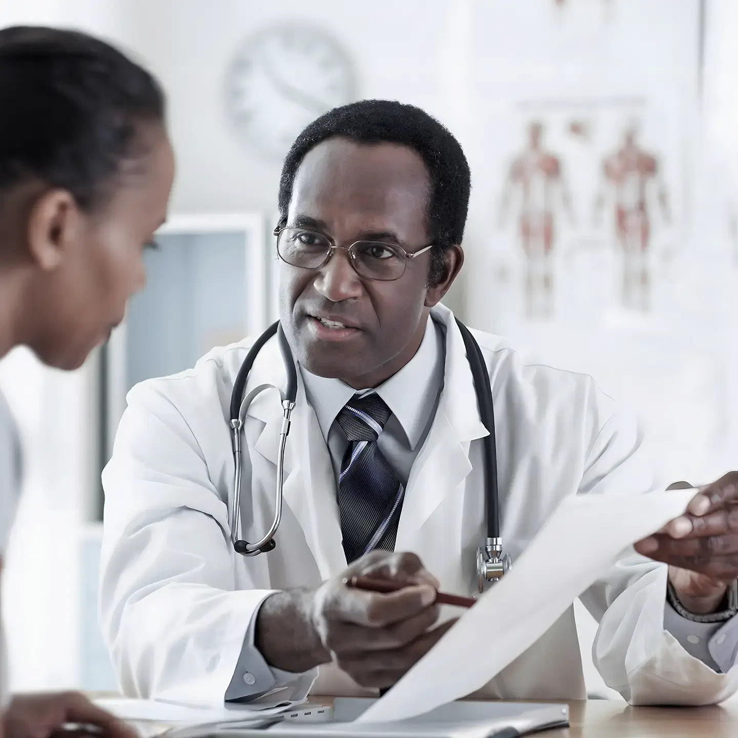 A doctor discusses a health condition with a young female patient.